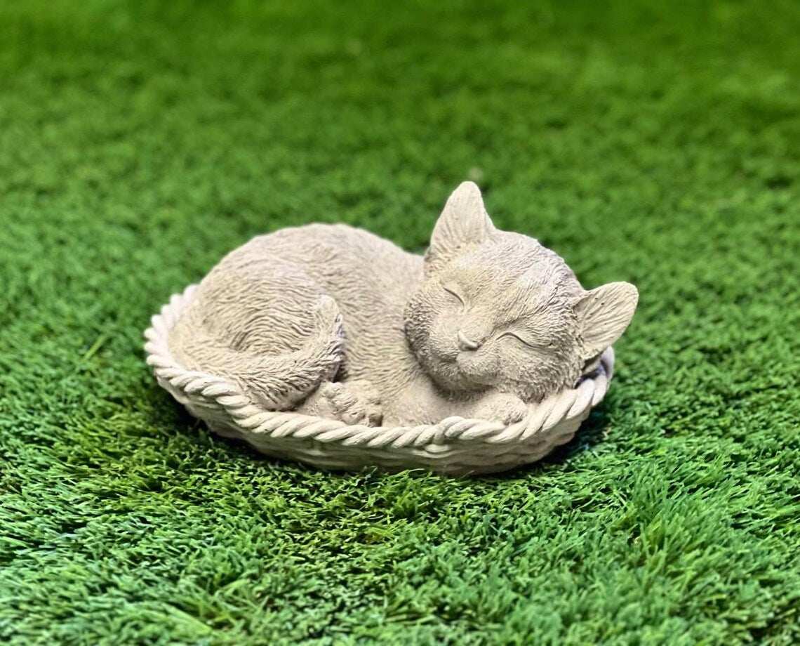 Sleeping cat in basket statue