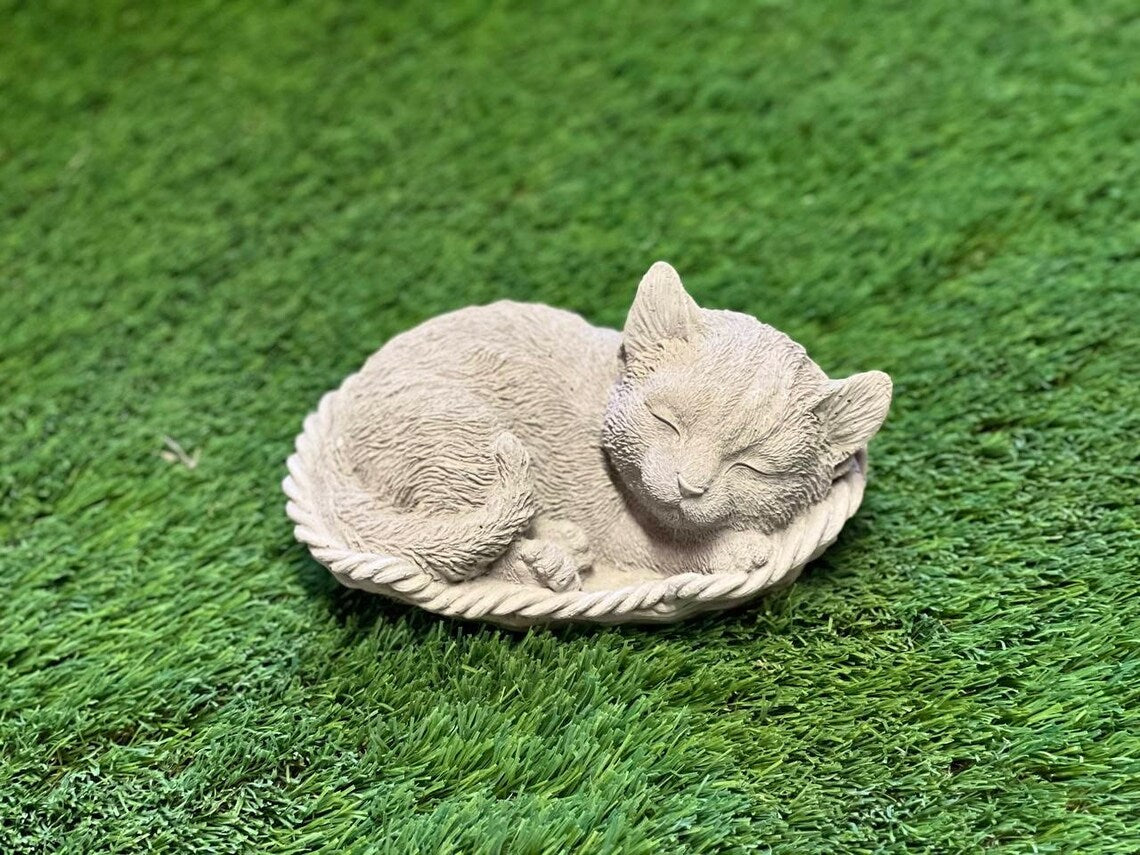 Sleeping cat in basket statue