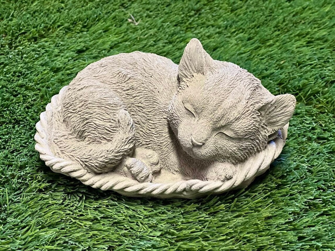 Sleeping cat in basket statue