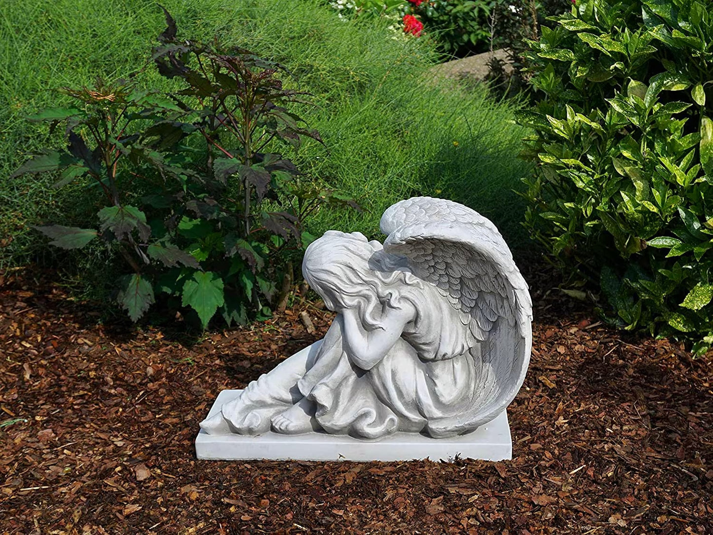 Massive concrete angel on base with foot out