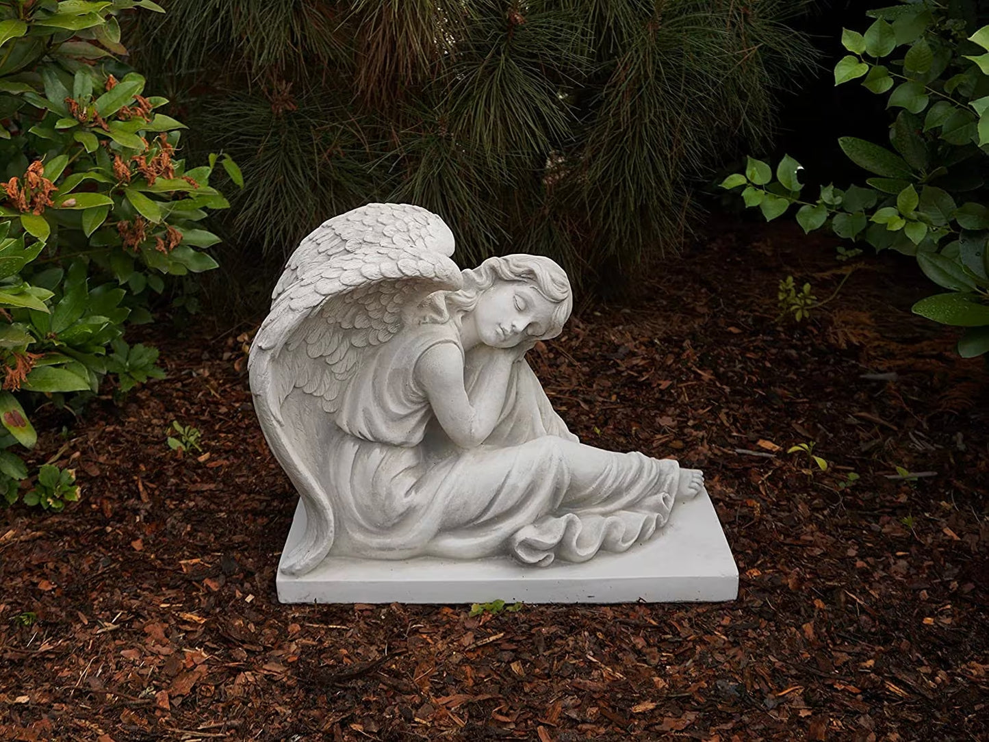 Massive concrete angel on base with foot out
