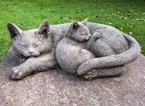 Two curled up sleeping cats statue