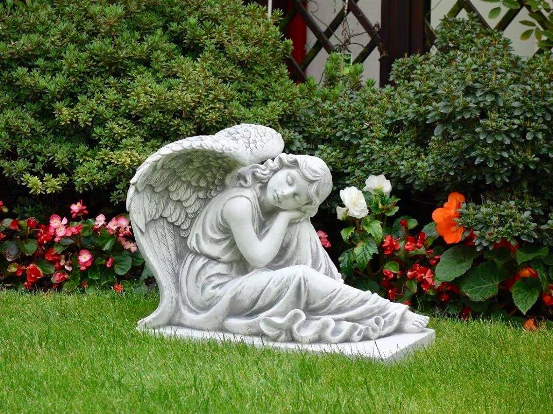 Massive concrete angel on base with foot out